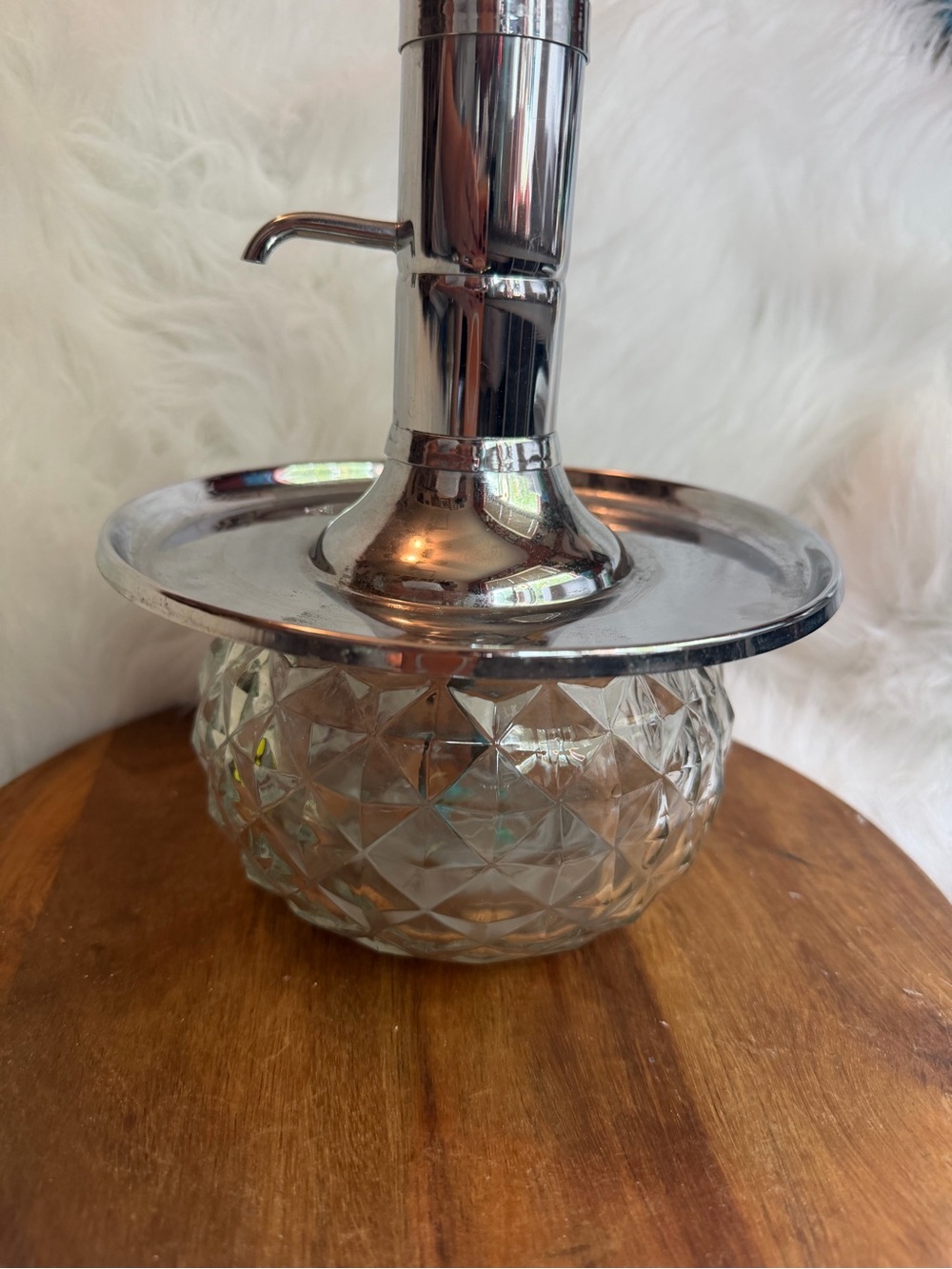 A vintage Park Sherman chrome and glass liquor dispenser with a metal tray.